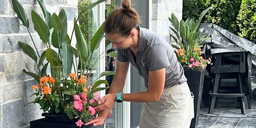 Wasson seasonal color crew installing porch pots on a patio