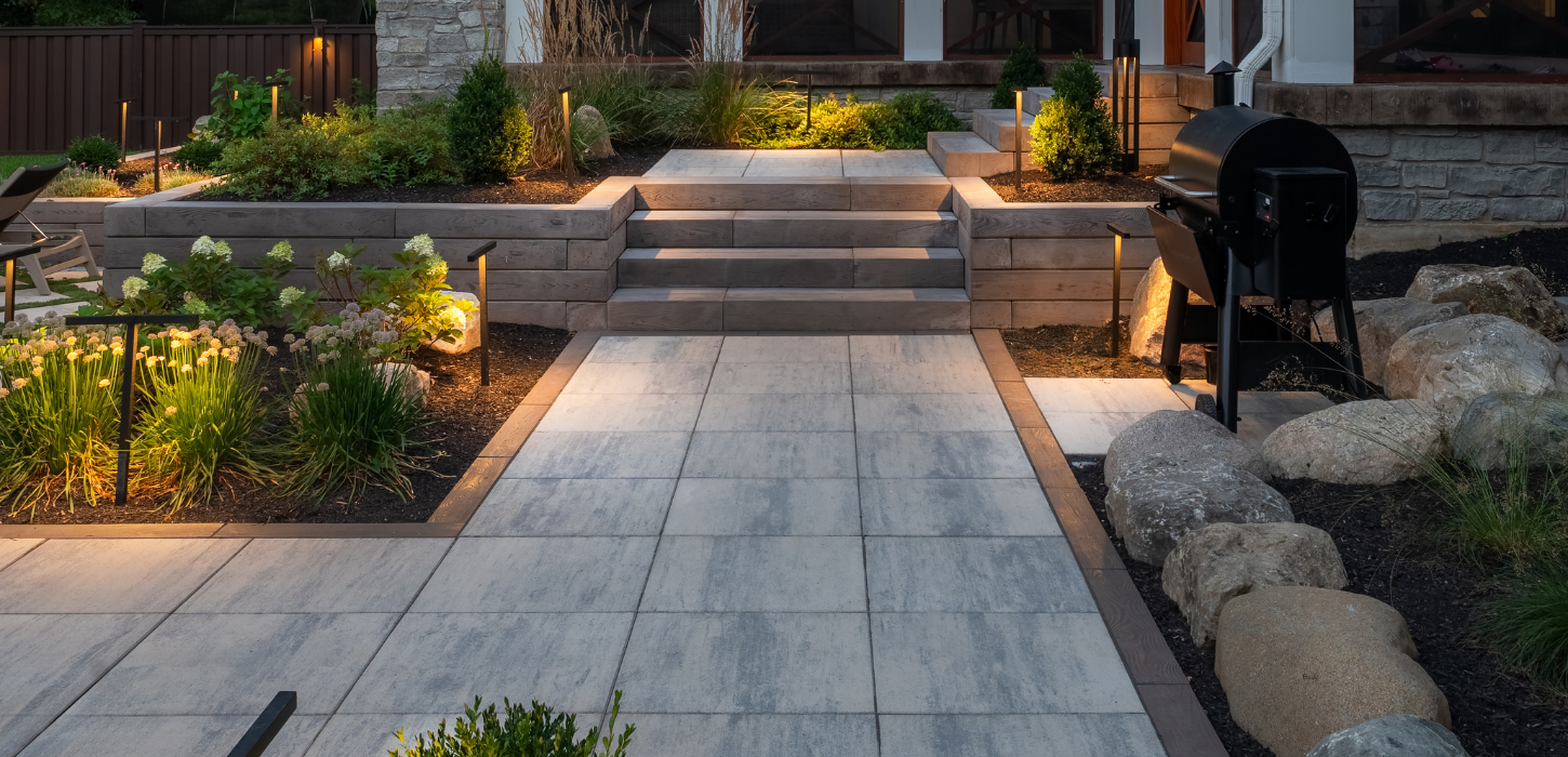 outdoor living space with modern landscape design and natural stone patio