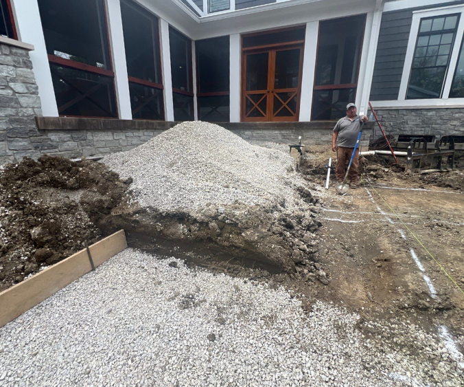 A wide-angle picture showing a steep elevation change between the foot of the doorstep to the ground, which needs hardscaping to connect the two.